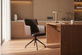 Modern brown chair with spider-like legs against a concrete wall.