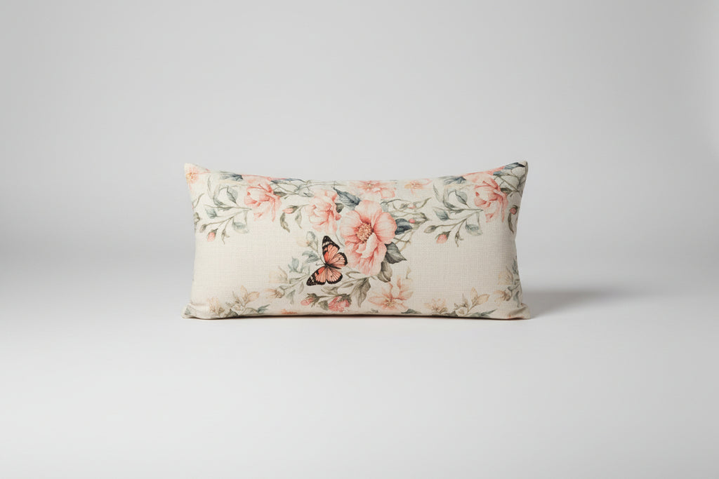 Floral-patterned pillow on a textured sofa with a remote control on the armrest.