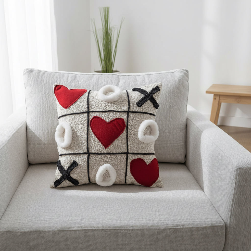Decorative pillow with heart and cross patterns on a white couch