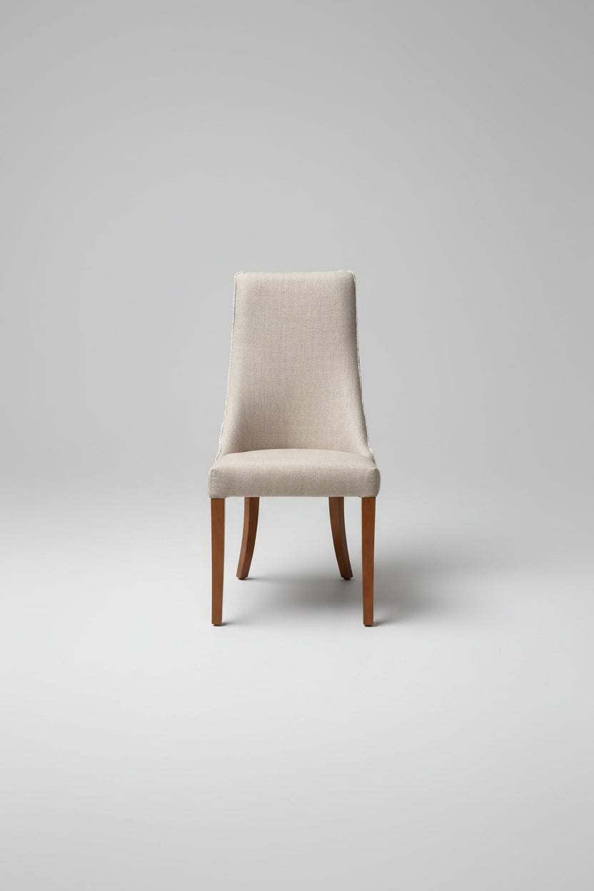 Chair with a white cushion on a concrete floor next to a textured wall.